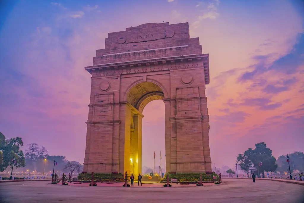 India Gate in New Delhi under a pink evening sky