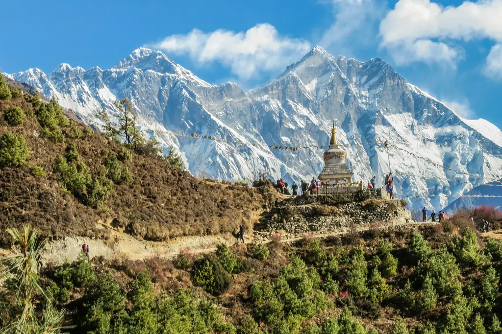 Stupa with prayer flags below snow peaks in the Everest region, Nepal